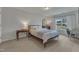 Comfortable bedroom with natural light from the windows, carpet, and neutral walls at 274 Roaring Creek Dr, Garner, NC 27529