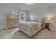 Bedroom with a light-colored bed, white walls, bedside tables, and ample natural light from a window at 274 Roaring Creek Dr, Garner, NC 27529