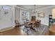 Bright dining room featuring hardwood floors, classic trim work, and a stylish chandelier at 274 Roaring Creek Dr, Garner, NC 27529