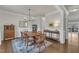 Dining room with hardwood floors, light gray walls, wooden dining table, and a decorative area rug at 274 Roaring Creek Dr, Garner, NC 27529