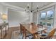 Dining room featuring hardwood floors, light gray walls, a wooden dining table, and bright natural light at 274 Roaring Creek Dr, Garner, NC 27529