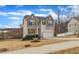 Inviting two-story home with a two-car garage, a cozy front porch, and established landscaping at 274 Roaring Creek Dr, Garner, NC 27529