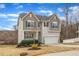 Lovely two-story home with a front porch, complemented by a two-car garage and mature trees at 274 Roaring Creek Dr, Garner, NC 27529