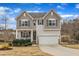 Charming two-story home with a two-car garage, landscaped front yard, and inviting front porch at 274 Roaring Creek Dr, Garner, NC 27529