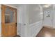 Hallway featuring hardwood floors, white walls, and classic trim leading to the front door at 274 Roaring Creek Dr, Garner, NC 27529