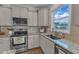 Bright kitchen features granite countertops, stainless steel appliances, and light gray cabinetry at 274 Roaring Creek Dr, Garner, NC 27529