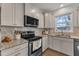Modern kitchen features stainless steel appliances, granite counters, and light gray cabinets at 274 Roaring Creek Dr, Garner, NC 27529