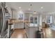 Spacious kitchen features stainless appliances, an island, and sliding doors leading to an outdoor deck at 274 Roaring Creek Dr, Garner, NC 27529
