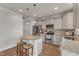 The kitchen features a granite island with seating, hardwood floors, and stainless steel appliances at 274 Roaring Creek Dr, Garner, NC 27529