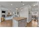 Open-concept living area with hardwood floors, granite island seating, and living and dining areas at 274 Roaring Creek Dr, Garner, NC 27529