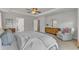 Spacious primary bedroom features a tray ceiling, neutral walls, and an accent chair at 274 Roaring Creek Dr, Garner, NC 27529