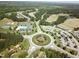 Aerial view of the community with a pool, clubhouse, tennis courts, and lush landscapes surrounded by houses at 297 Colonial Ridge Dr, Pittsboro, NC 27312