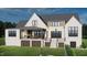 Rear exterior elevation of a home with a covered patio including an outdoor dining set at 297 Colonial Ridge Dr, Pittsboro, NC 27312