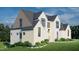 Charming exterior elevation of a two-story home with gray roof and manicured lawn at 297 Colonial Ridge Dr, Pittsboro, NC 27312