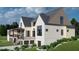 Side and rear exterior elevation of a home with a covered patio and manicured landscaping at 297 Colonial Ridge Dr, Pittsboro, NC 27312