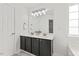 Well-lit bathroom with a double sink, large mirror, and modern light fixture at 315 Inkster Cv, Raleigh, NC 27603