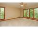 Bright bedroom featuring large windows showcasing scenic views of nature at 3306 Whitfield Rd, Chapel Hill, NC 27514