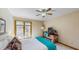 Cozy bedroom featuring a ceiling fan, wooden desk, and a window overlooking the surrounding nature at 3306 Whitfield Rd, Chapel Hill, NC 27514