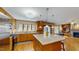 Bright, open kitchen with stainless steel appliances, granite countertops, and an island with barstool seating at 3306 Whitfield Rd, Chapel Hill, NC 27514