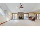 Spacious living room with fireplace, a ceiling fan, and access to the deck at 3306 Whitfield Rd, Chapel Hill, NC 27514