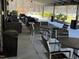 Outdoor patio with comfortable seating and tables overlooking a tennis court at 3306 Whitfield Rd, Chapel Hill, NC 27514