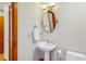 Classic powder room featuring a pedestal sink, oval mirror, and tasteful fixtures at 3306 Whitfield Rd, Chapel Hill, NC 27514