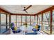 Inviting sunroom with a ceiling fan, and views of the surrounding nature, perfect for relaxation at 3306 Whitfield Rd, Chapel Hill, NC 27514