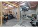 Unfinished basement with exposed ceiling, gym, storage, and utilities at 3418 Longleaf Estates Dr, Raleigh, NC 27616