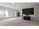 Basement view featuring large TV, neutral carpet and natural light at 3418 Longleaf Estates Dr, Raleigh, NC 27616