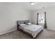 Neutral bedroom features a gray bed frame, plush carpet and sunny window views at 3418 Longleaf Estates Dr, Raleigh, NC 27616