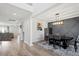 Bright dining room with hardwood floors, decorative wall trim, modern lighting, and an open floorplan at 3418 Longleaf Estates Dr, Raleigh, NC 27616