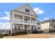 Charming two-story home with a two-car garage, a double stacked front porch, and landscaped front yard at 3418 Longleaf Estates Dr, Raleigh, NC 27616
