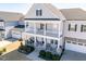 Charming two-story home with a double porch, stone accents, and a well-manicured front yard at 3418 Longleaf Estates Dr, Raleigh, NC 27616