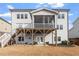 Rear exterior view of a home with a second story porch and patio with backyard space at 3418 Longleaf Estates Dr, Raleigh, NC 27616
