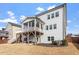 Rear exterior view of a two-story home with porch and patio with backyard at 3418 Longleaf Estates Dr, Raleigh, NC 27616