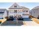 Charming two-story home with a spacious front porch and a two-car garage and neutral paint at 3418 Longleaf Estates Dr, Raleigh, NC 27616