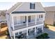 Stylish two-story home with a charming front porch and stone accents, offering an inviting curb appeal at 3418 Longleaf Estates Dr, Raleigh, NC 27616