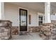 Close up of front porch columns with stacked stone, a black front door, and house numbers at 3418 Longleaf Estates Dr, Raleigh, NC 27616