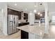 Modern kitchen featuring granite countertops, stainless steel appliances and dark cabinetry at 3418 Longleaf Estates Dr, Raleigh, NC 27616
