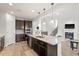 Open kitchen boasts stainless steel appliances, granite countertops and seamless flow to living area at 3418 Longleaf Estates Dr, Raleigh, NC 27616