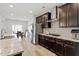 Open kitchen featuring granite countertops, stainless steel appliances, and dark cabinetry at 3418 Longleaf Estates Dr, Raleigh, NC 27616