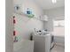 Functional laundry room with sink, white washer and dryer, and wire shelving at 3418 Longleaf Estates Dr, Raleigh, NC 27616