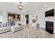 Spacious living room with fireplace, hardwood floors, and an open floor plan to the kitchen at 3418 Longleaf Estates Dr, Raleigh, NC 27616
