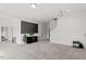 Bright and spacious living room features a large TV and cozy carpet at 3418 Longleaf Estates Dr, Raleigh, NC 27616