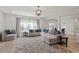 Spacious living room with light gray walls, a comfortable L-shaped sofa, and plenty of natural light at 3418 Longleaf Estates Dr, Raleigh, NC 27616