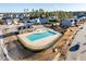 Aerial view of community pool and clubhouse in a suburban neighborhood at 3418 Longleaf Estates Dr, Raleigh, NC 27616