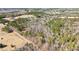 Expansive aerial view of a wooded property with a dirt road winding through the trees at 348 Raymond Tharrington Rd, Louisburg, NC 27549