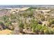 A captivating aerial perspective showcasing a vast tract of land with scattered vegetation at 348 Raymond Tharrington Rd, Louisburg, NC 27549