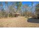 Large backyard featuring a charming shed and natural surroundings at 348 Raymond Tharrington Rd, Louisburg, NC 27549