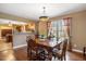 Elegant dining room with hardwood floors, a chandelier, and a view to the kitchen at 348 Raymond Tharrington Rd, Louisburg, NC 27549
